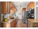 Updated kitchen featuring warm wood cabinets, granite counters, and stainless steel appliances with great natural light at 4323 W Ponds Cir, Littleton, CO 80123
