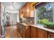 Charming kitchen with warm wood cabinetry, granite countertops, and an adjacent dining area with plenty of natural light at 4323 W Ponds Cir, Littleton, CO 80123