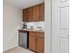 Cozy kitchenette featuring a mini-fridge, sink, and wooden cabinets, perfect for convenience and style at 4323 W Ponds Cir, Littleton, CO 80123