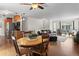 Open-concept living room featuring hardwood floors and a seamless transition to the kitchen and dining area at 4323 W Ponds Cir, Littleton, CO 80123