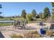Relaxing patio area with outdoor seating overlooking a serene lake and green spaces at 4323 W Ponds Cir, Littleton, CO 80123