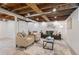 Finished basement with exposed wooden ceiling and neutral decor at 3052 S Logan St, Englewood, CO 80113
