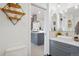Bathroom view leading to a kitchen with stainless steel appliances and a breakfast bar at 3052 S Logan St, Englewood, CO 80113