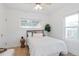 Bright bedroom with wood-look floors and natural light from two windows at 3052 S Logan St, Englewood, CO 80113