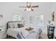 Sun-filled bedroom featuring wood-look floors, modern decor, and a ceiling fan at 3052 S Logan St, Englewood, CO 80113
