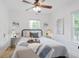 Bright bedroom with a ceiling fan, wood-look floors, and modern decor at 3052 S Logan St, Englewood, CO 80113