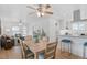 Open-concept dining area connecting the living room and kitchen at 3052 S Logan St, Englewood, CO 80113