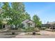 Inviting home exterior with a beautiful garden, lush landscaping, and a charming front porch at 3052 S Logan St, Englewood, CO 80113