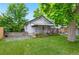Charming home with a well-manicured lawn, beautiful landscaping, and a welcoming front porch at 3052 S Logan St, Englewood, CO 80113