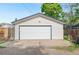 A well-maintained two-car garage with a clean, white door and ample parking space at 3052 S Logan St, Englewood, CO 80113