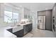 Stylish kitchen featuring stainless steel appliances and a farmhouse sink at 3052 S Logan St, Englewood, CO 80113