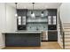 Stylish bar area with custom cabinetry, mosaic backsplash, and a stainless steel beverage center at 5145 S Kearney Ct, Greenwood Village, CO 80111