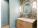 Stylish powder room with a unique mirror and sink with a leafy wallpaper at 5145 S Kearney Ct, Greenwood Village, CO 80111