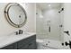 Contemporary bathroom with a glass shower, and a vanity with round mirror at 5145 S Kearney Ct, Greenwood Village, CO 80111
