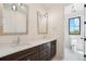 Bright bathroom featuring a double vanity, marble countertops, and modern fixtures at 5145 S Kearney Ct, Greenwood Village, CO 80111