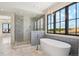 Bright bathroom features standalone tub and spacious glass-enclosed shower with herringbone tile at 5145 S Kearney Ct, Greenwood Village, CO 80111
