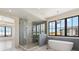 Bright bathroom features standalone tub and spacious glass-enclosed shower with herringbone tile at 5145 S Kearney Ct, Greenwood Village, CO 80111