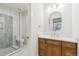 Well-lit bathroom featuring a glass enclosed shower, marble countertops, and wood vanity at 5145 S Kearney Ct, Greenwood Village, CO 80111
