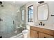 Spa-like bathroom with a glass-enclosed shower, and a modern vanity with a black trimmed mirror at 5145 S Kearney Ct, Greenwood Village, CO 80111