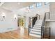 Bright entryway with hardwood floors, staircase, and modern lighting at 5145 S Kearney Ct, Greenwood Village, CO 80111