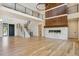 Open-concept living area with a fireplace, hardwood floors, and modern staircase at 5145 S Kearney Ct, Greenwood Village, CO 80111