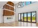 Open living room with a modern fireplace, hardwood floors, and large sliding glass doors at 5145 S Kearney Ct, Greenwood Village, CO 80111