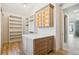 Well-organized walk-in closet has custom shelving, cabinets, and center island at 5145 S Kearney Ct, Greenwood Village, CO 80111