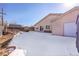 Snow-covered backyard with shed and partial house view at 5621 Demott Ave, Commerce City, CO 80022