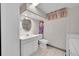 Basement bathroom with shower, toilet, vanity, and washer/dryer hookups at 5621 Demott Ave, Commerce City, CO 80022