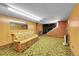 Finished basement area with a sofa and carpeted floor at 5621 Demott Ave, Commerce City, CO 80022