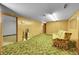Finished basement with sofa and additional storage space at 5621 Demott Ave, Commerce City, CO 80022