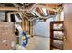 Unfinished basement with furnace and storage shelving at 5621 Demott Ave, Commerce City, CO 80022