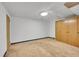 Unfinished basement room with carpeted floor and closet at 5621 Demott Ave, Commerce City, CO 80022