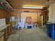 Garage with overhead storage and cabinets at 5621 Demott Ave, Commerce City, CO 80022