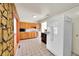 Kitchen with wood cabinets, tiled floor, and appliances at 5621 Demott Ave, Commerce City, CO 80022