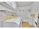 Clean laundry room featuring a washer, dryer, and overhead storage at 5621 Demott Ave, Commerce City, CO 80022