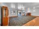 Spacious living room with hardwood floors, fireplace, and large windows at 5621 Demott Ave, Commerce City, CO 80022