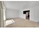 Bright living room with large windows and neutral carpeting at 5621 Demott Ave, Commerce City, CO 80022