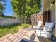 Outdoor seating area showcasing a patio and fenced yard with a lush green lawn at 9736 W Cornell Pl, Lakewood, CO 80227