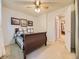 Comfortable bedroom with neutral carpet, ceiling fan, and views into an adjacent bedroom at 9736 W Cornell Pl, Lakewood, CO 80227
