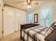Bedroom features a bed, carpet, and bright windows at 9736 W Cornell Pl, Lakewood, CO 80227