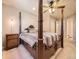 Main bedroom with a canopy bed, carpeted floors, and window views at 9736 W Cornell Pl, Lakewood, CO 80227