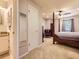 Spacious main bedroom with a canopy bed, ceiling fan, and ensuite bathroom at 9736 W Cornell Pl, Lakewood, CO 80227