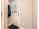 Clean entryway with a door featuring a window and a durable floor mat at 9736 W Cornell Pl, Lakewood, CO 80227