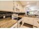 Modern kitchen with white cabinets, granite countertops, and stainless steel appliances at 9736 W Cornell Pl, Lakewood, CO 80227