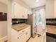 Cozy kitchen features a stainless steel refrigerator, granite countertops, and mosaic tile backsplash at 9736 W Cornell Pl, Lakewood, CO 80227