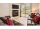 Living room with sliding glass door to backyard and white stone fireplace feature at 9736 W Cornell Pl, Lakewood, CO 80227