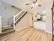 Open floor plan living room with hardwood floors and stairway access to the second floor at 9736 W Cornell Pl, Lakewood, CO 80227