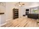 The living room features modern flooring, a ceiling fan, and a cozy stone fireplace at 9736 W Cornell Pl, Lakewood, CO 80227