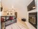 Bright living room features a stone fireplace, leather sofa, and open floor plan at 9736 W Cornell Pl, Lakewood, CO 80227
